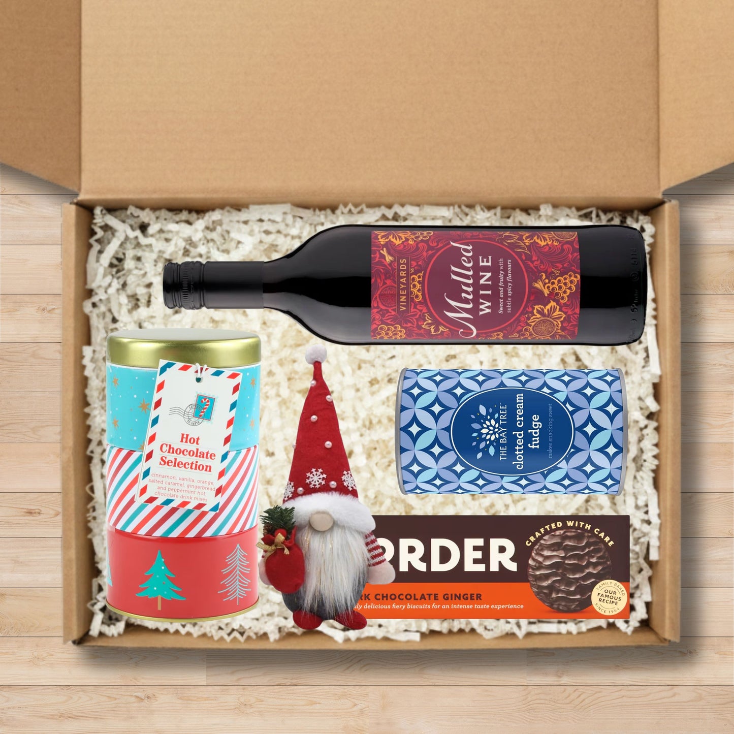 Gift set with vineyards mulled wine, Festive Hot Chocolate Tin Selection, The Bay Tree Clotted Cream Fudge Tube, Border Dark Chocolate Ginger Biscuits, and a gnome plushie