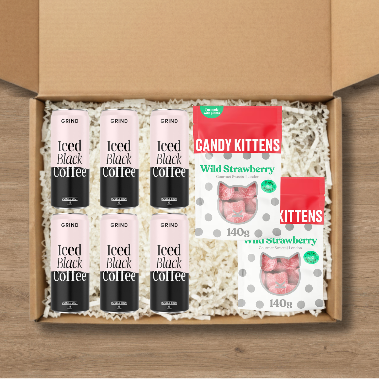 6 cans of Grind blacked iced coffee and 2 packs of Candy Kittens wild strawberry sweets.