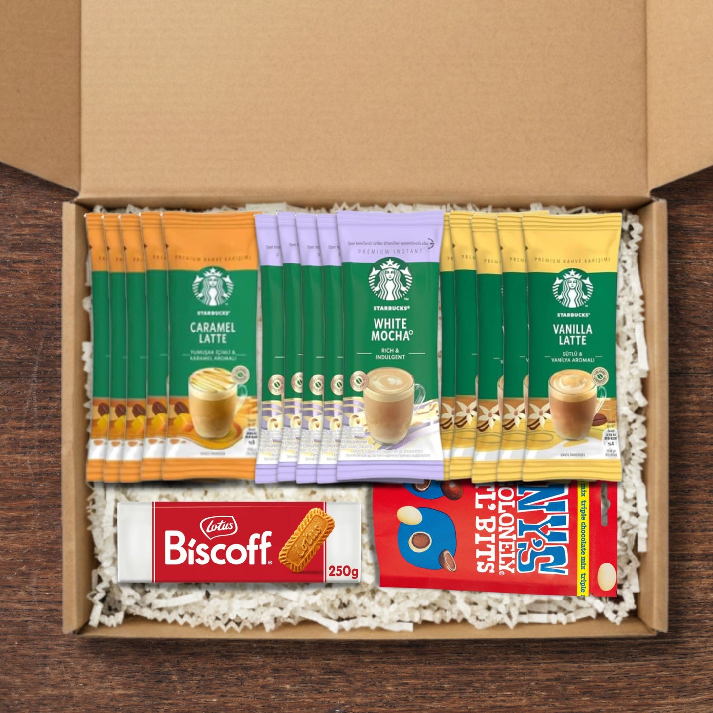 Gift box containing Starbucks coffee sachets, Biscoff cookies and Tony's Chocolonely littl bits