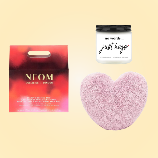 NEOM Energy Boosting Trio set, a candle and a fluffy heart shaped cushion