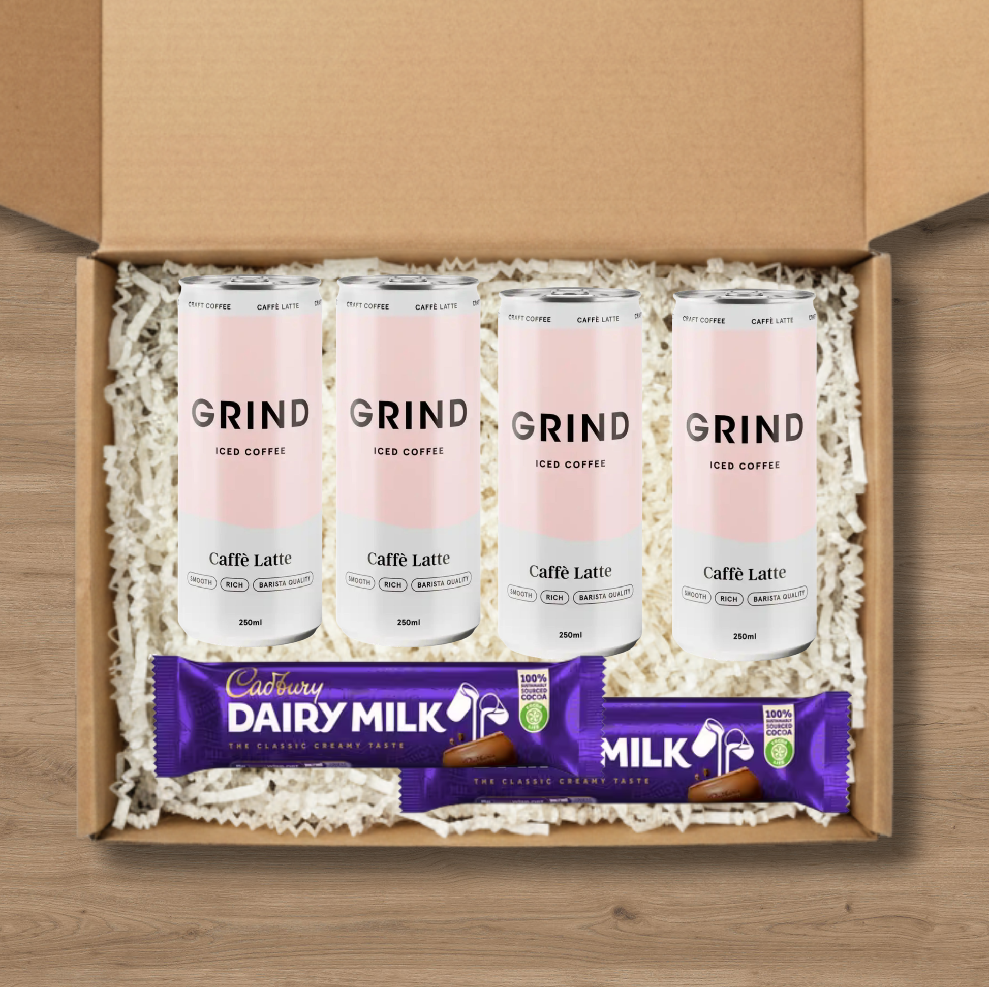 4 cans of Grind Caffe Latte Iced Coffee and 2 Cadbury Dairy Milk chocolate bars