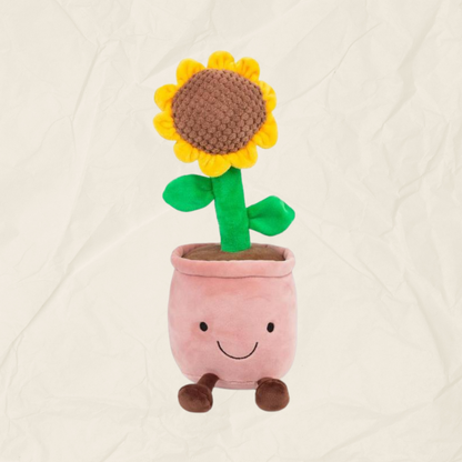 A plushie of a green, yellow and brown sunflower in a pink plant pot.
