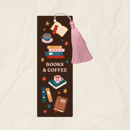 A dark brown bookmark with a design featuring colourful books and coffee cups, along with a pink tassel.