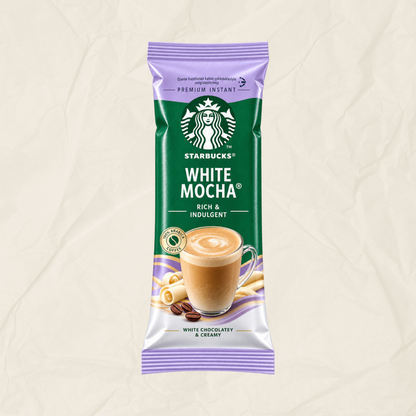 A single packet of Starbucks White Mocha instant coffee on a textured beige background. The packaging is primarily green with purple accents at the top and bottom, featuring the Starbucks logo and an illustration of a cup of white chocolate mocha.