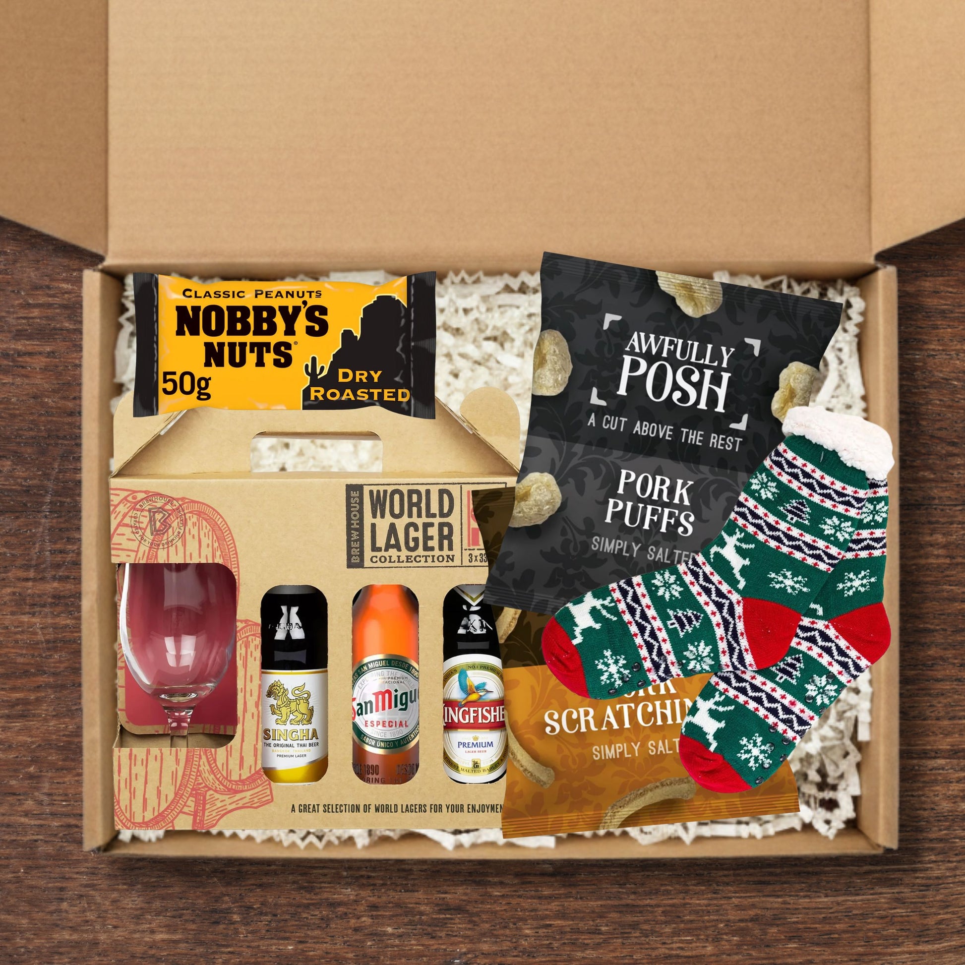 Gift box containing a lager gift set, socks, awfully posh snacks, and nobby's nuts.