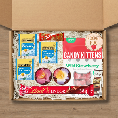 Gift box containing candy kittens, tea, candles, lindt chocolate, 2 celebrations hot chocolate sachets and a wooden round pocket hug