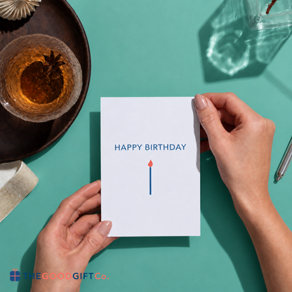 A "Happy Birthday" card being held between 2 hands