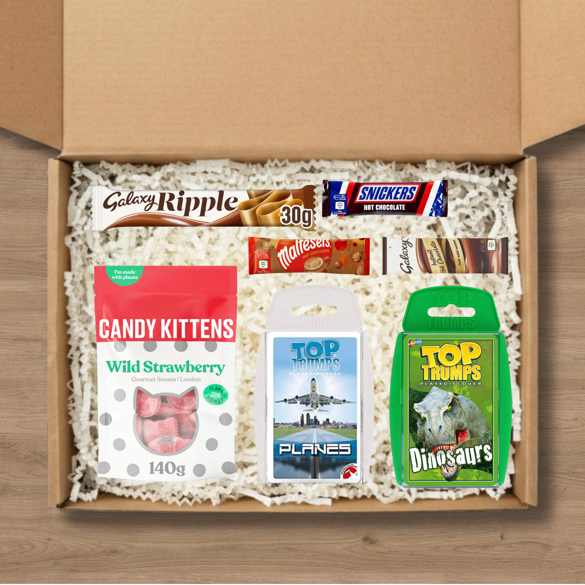 Gift set containing two Top Trumps quiz games, a Galaxy Ripple chocolate bar, candy kittens sweets, and celebrations hot chocolates