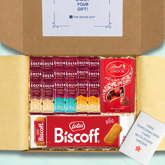 Gift box with yellow tissue paper and shredded paper packaging, containing: 6 Costa Coffee Latte sachets, 6 Costa Coffee Creamy Cappuccino sachets, 6 Costa Coffee Salted Caramel Latte sachets, a pack of 16 Biscoff biscuits and a 200g box of Lindt Lindor Milk Chocolate Truffles