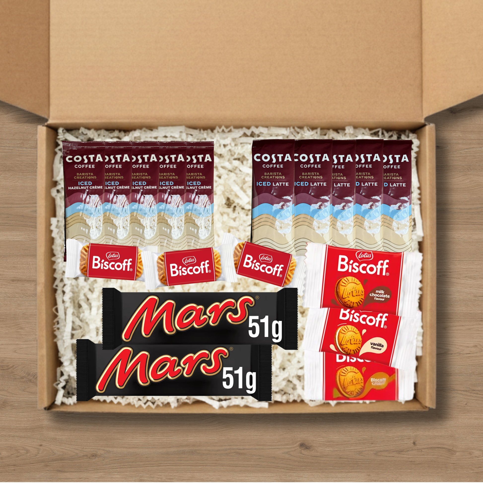 A gift box containing 5 costa coffee iced latte sachets, 5 costa coffee iced hazelnut creme coffee sachets, 3 packs of lotus biscoff biscuits, 1 pack each of lotus biscoff cream, biscoff vanilla cream, and biscoff milk chocolate cream biscuits, and 2 Mars chocolate bars