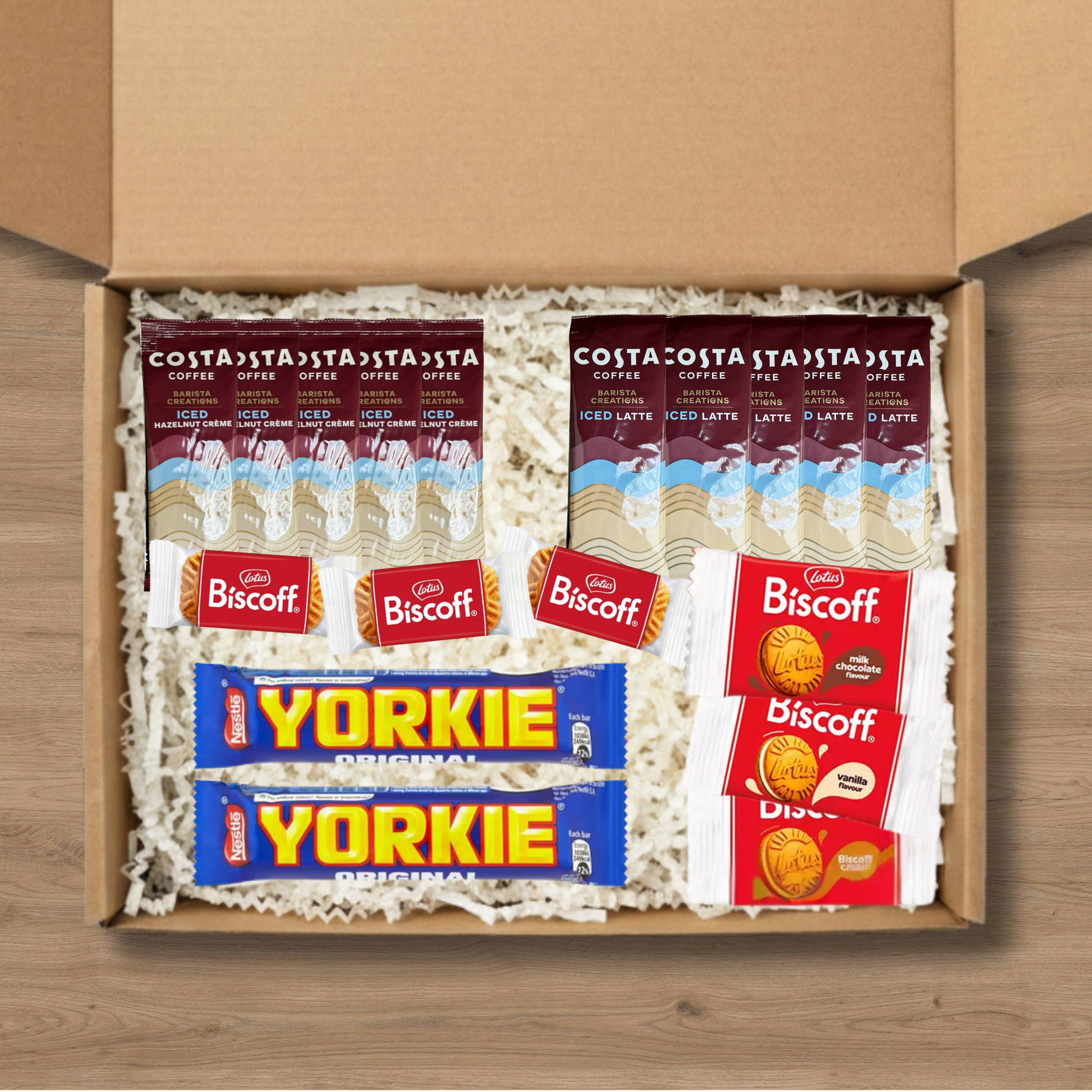 A gift box containing 5 costa coffee iced latte sachets, 5 costa coffee iced hazelnut creme coffee sachets, 3 packs of lotus biscoff biscuits, 1 pack each of lotus biscoff cream, biscoff vanilla cream, and biscoff milk chocolate cream biscuits, and 2 Yorkie chocolate bars