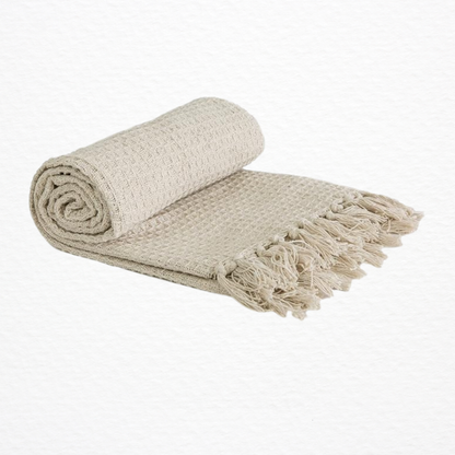 An Emma Barclay Honeycomb Throw rolled up