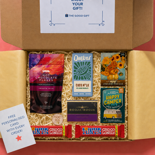 Gift box containing Ombar mylk chocolate, GNAW hot chocolate flakes, Booja-Booja chocolate truffles, Tony's Chocoloney, activities, and a pocket hug