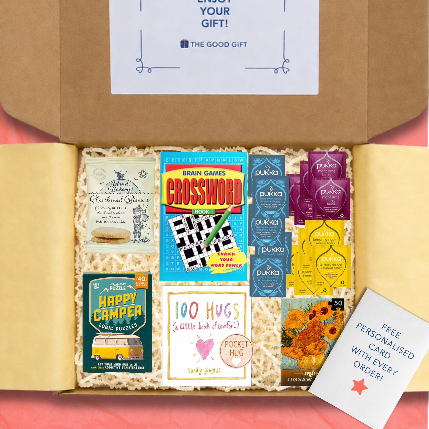 Gift box containing 5 Pukka Lemon, Ginger & Manuka Honey tea,bags, 5 Pukka Night Time Berry tea bags, 5 Pukka Chamomile, Vanilla & Manuka Honey tea bags, a 100 Hugs book, shortbread biscuits, a Happy Camper game, a masterworks jigsaw puzzle, a crossword book, and a pocket hug