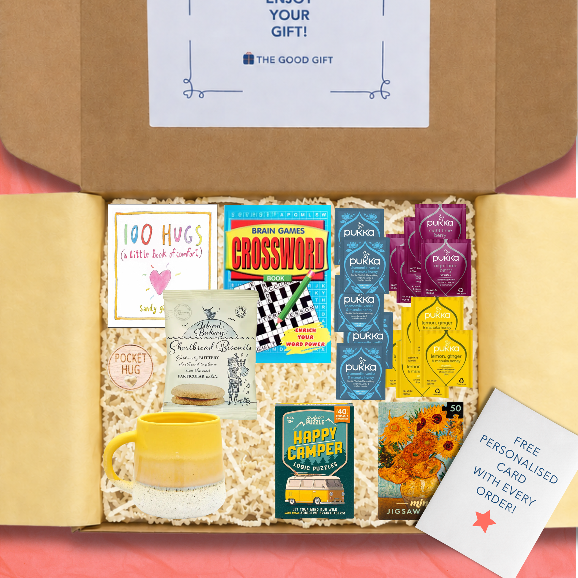 Gift box containing 5 Pukka Lemon, Ginger & Manuka Honey tea,bags, 5 Pukka Night Time Berry tea bags, 5 Pukka Chamomile, Vanilla & Manuka Honey tea bags, a 100 Hugs book, shortbread biscuits, a Happy Camper game, a masterworks jigsaw puzzle, a crossword book, a yellow mug, and a pocket hug