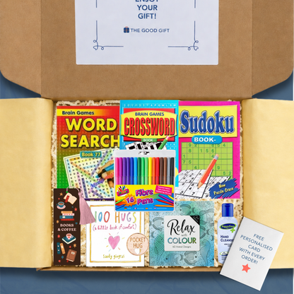 Gift box containing crossword, word search, sudoku and colouring books, a 100 Hugs book, a bookmark colouring felt tip pens, hand sanitiser, and a pocket hug