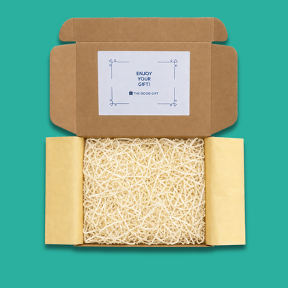 An open gift box showing yellow tissue paper and shredded packaging.