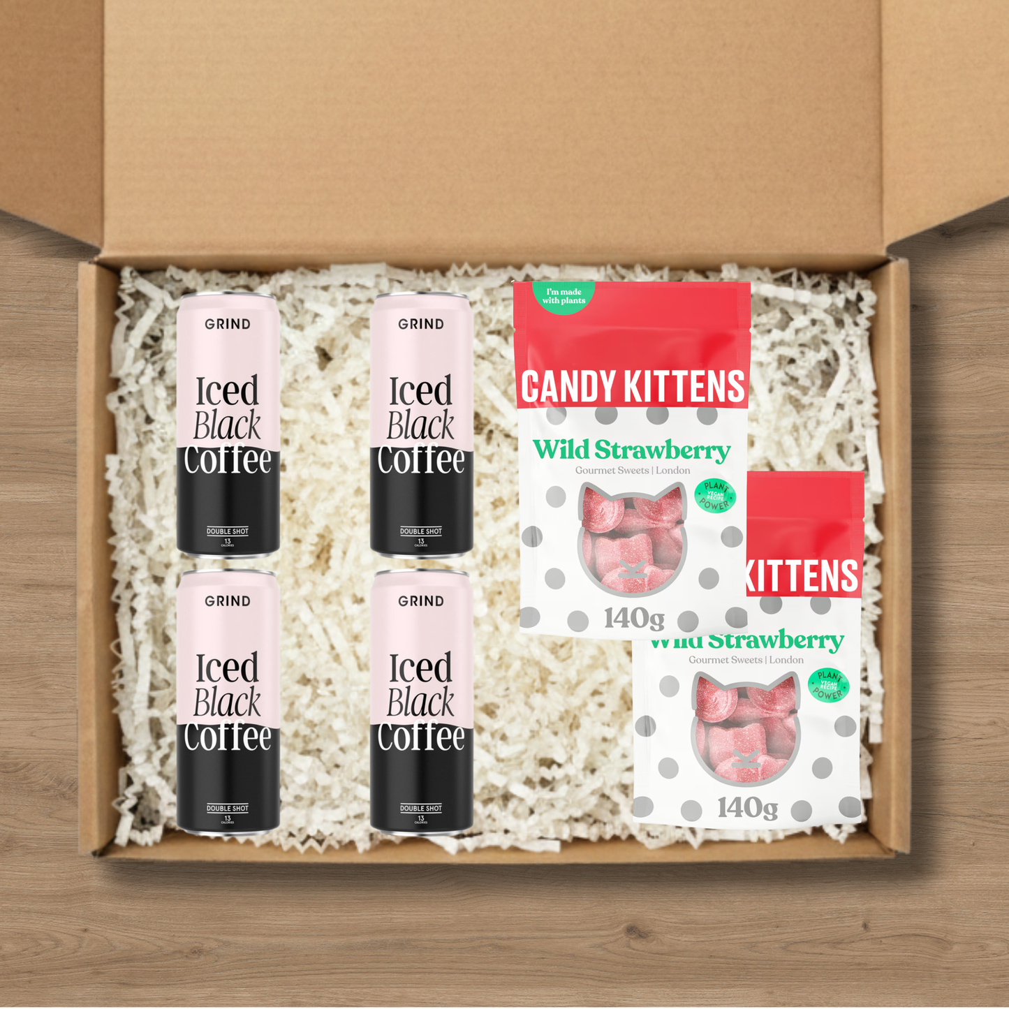 4 cans of Grind blacked iced coffee and 2 packs of Candy Kittens wild strawberry sweets.