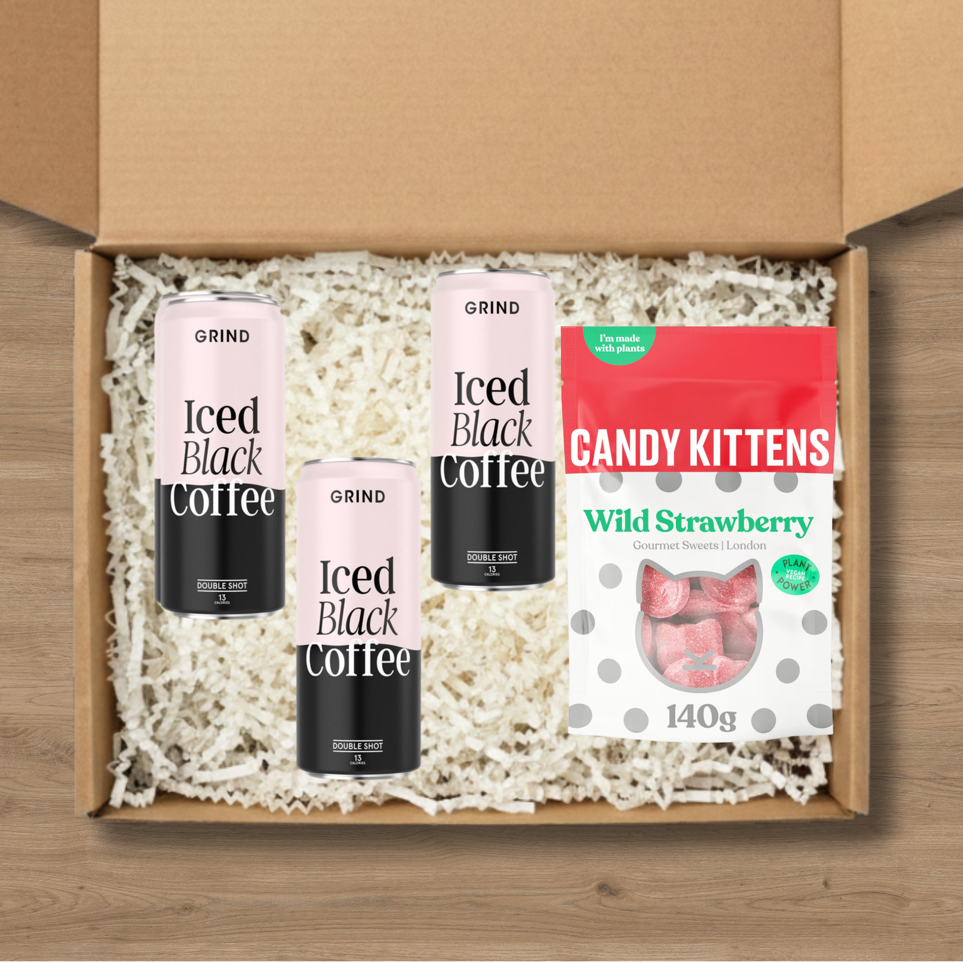 3 cans of Grind blacked iced coffee and 1 pack of Candy Kittens wild strawberry sweets.