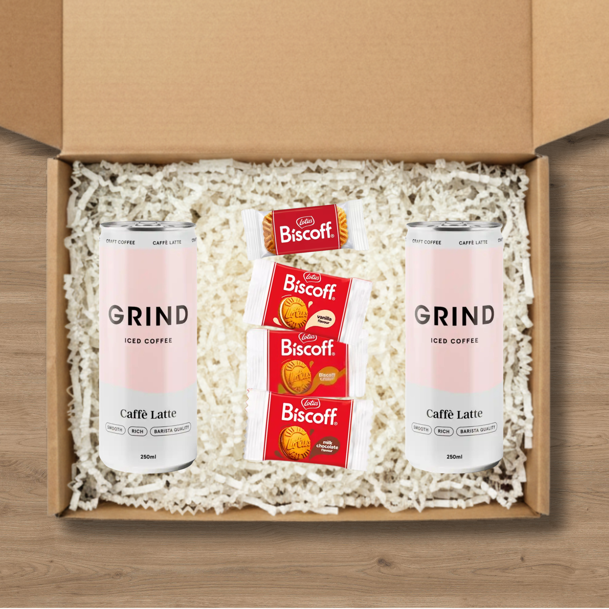 2 cans of Grind iced latte and a selection of Lotus Biscoff biscuits