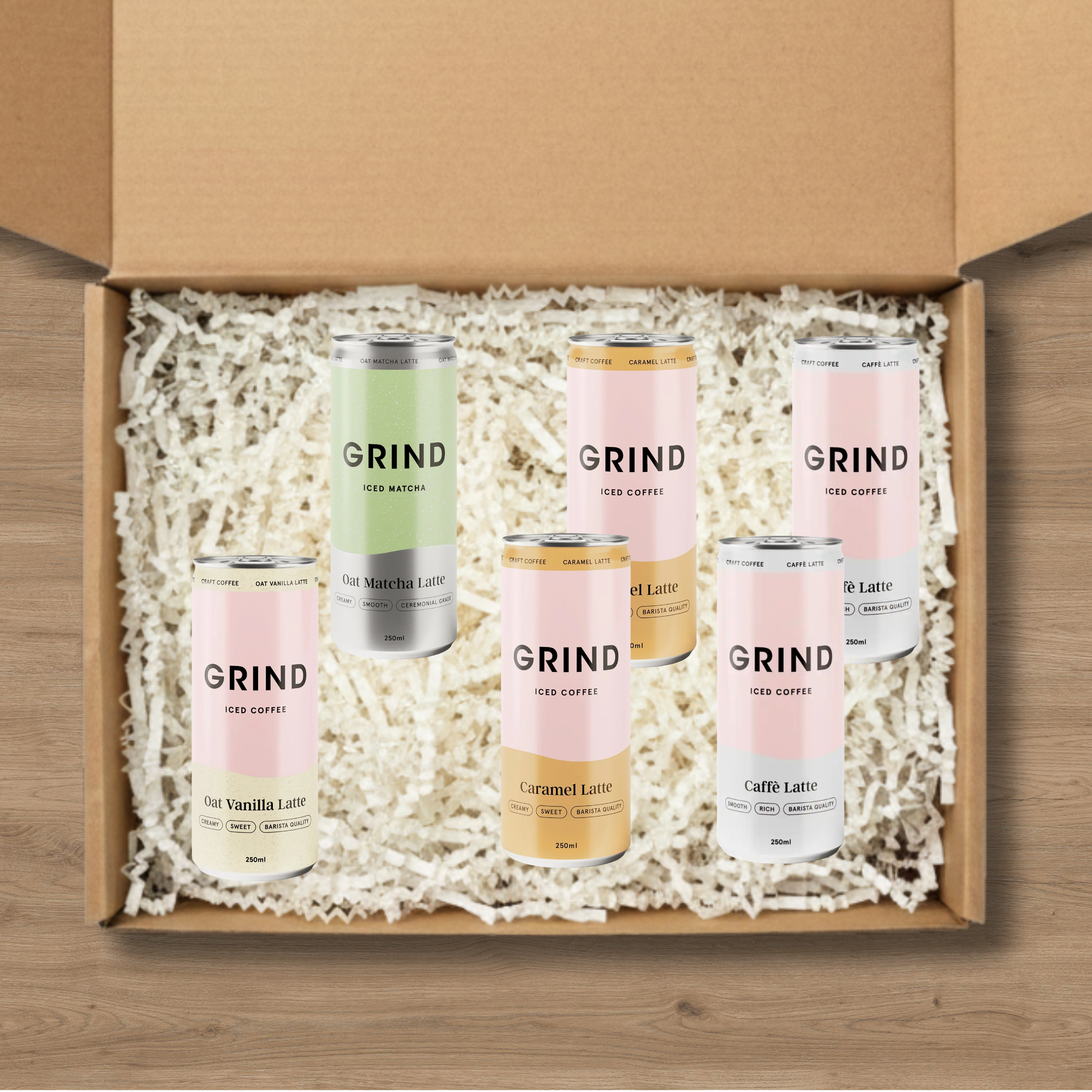 A selection of Grind iced coffees: 2 Cafe Latte Iced Coffees, 2 Grind Caramel Latte Iced Coffees, an Iced Matcha, and an Oat Vanilla Latte Iced Coffee