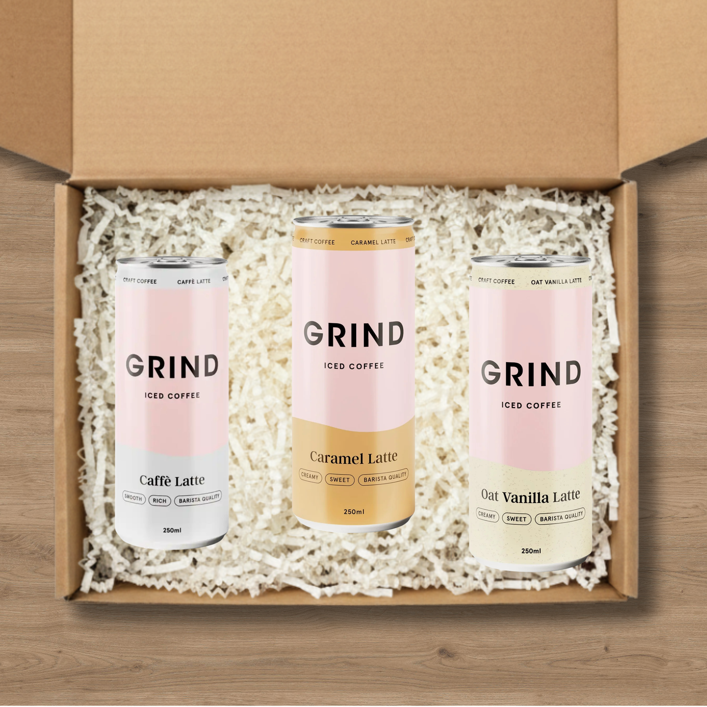 A selection of Grind iced coffees: a Cafe Latte Iced Coffee, a Grind Caramel Latte Iced Coffee, and an Oat Vanilla Latte Iced Coffee