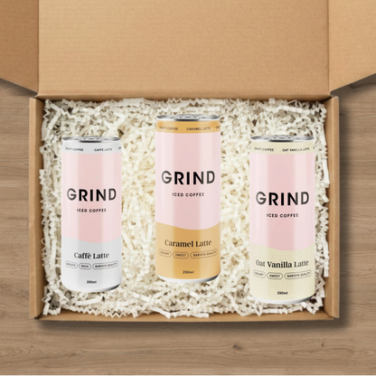 A selection of Grind iced coffees: a Cafe Latte Iced Coffee, a Grind Caramel Latte Iced Coffee, and an Oat Vanilla Latte Iced Coffee