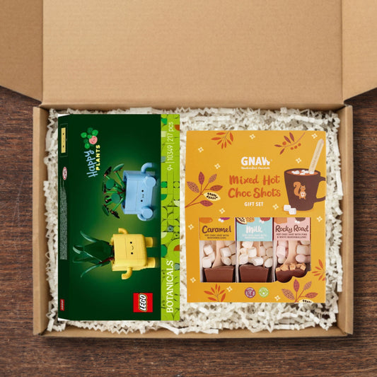 Gift box containing a LEGO Botanicals happy plants, and a GNAW Mixed Hot Choc Shots