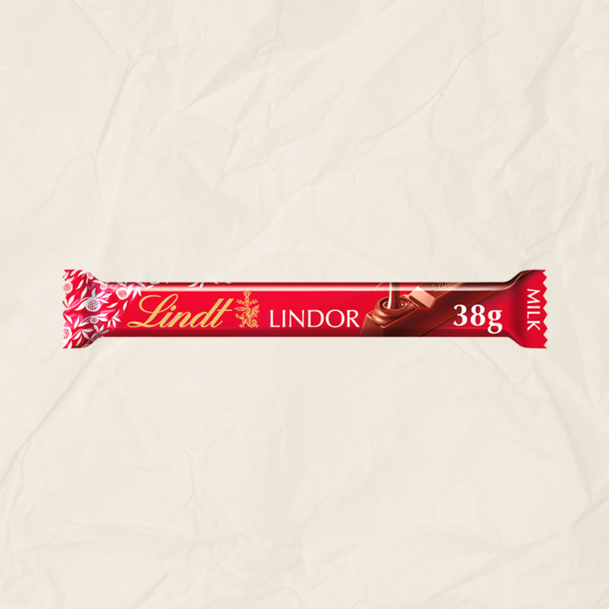 A Lindt Lindor 38g milk chocolate bar in its red wrapper, displayed horizontally against a textured, crumpled beige paper background.