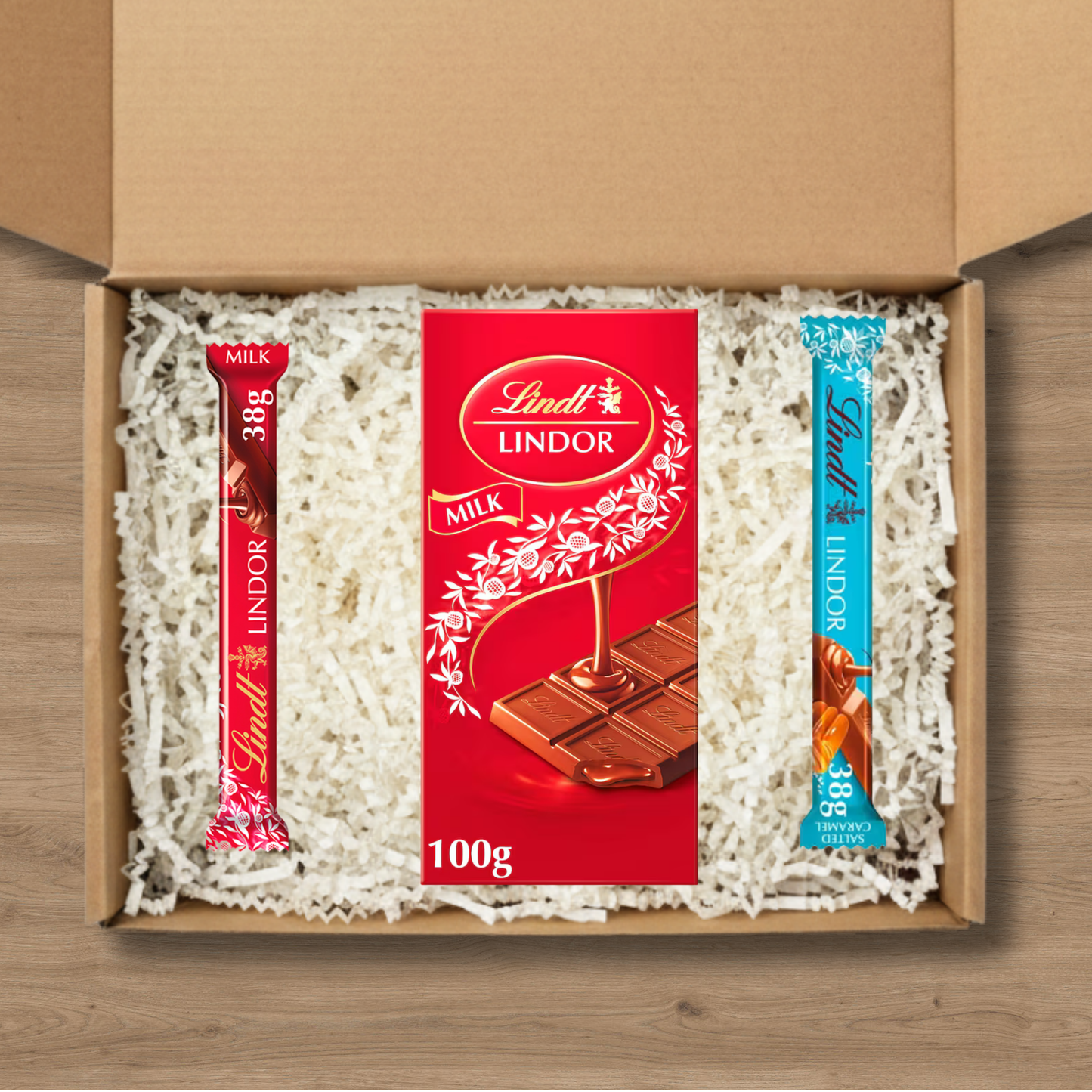 Lindt Lindor gift box with a 100g milk chocolate bar and milk and salted caramel sticks
