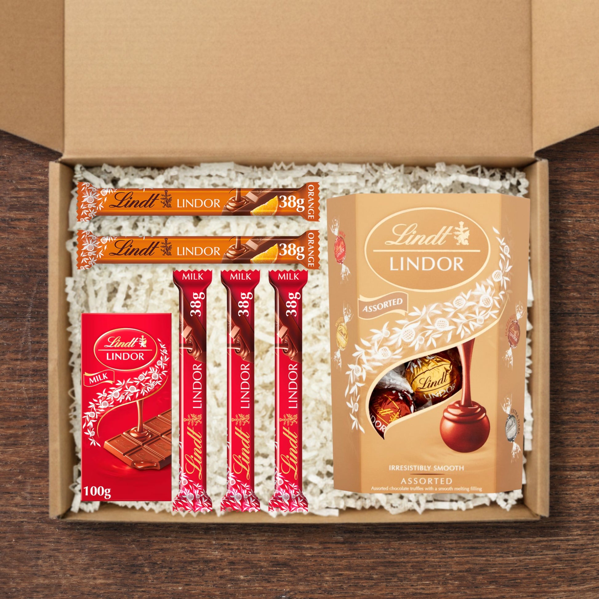 Gift box containing Lindt lindor cornets, lindt lindor chocolate bar, lindt lindor mini chocolate bars, and lindt lindor mini chocolate orange bars