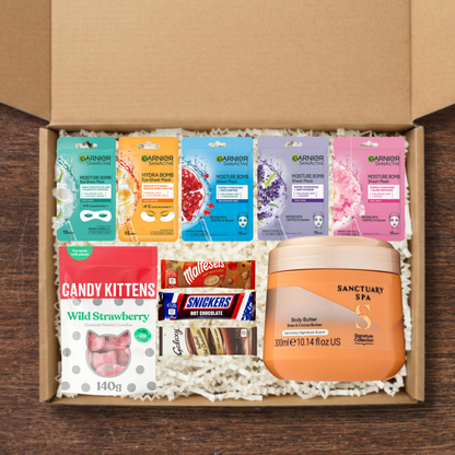 Gift set containing Garnier SkinActive facemasks, Sanctuary Spa Body Butter, Celebrations hot chocolate sachets, and Candy Kittens Wild Strawberry Sweets