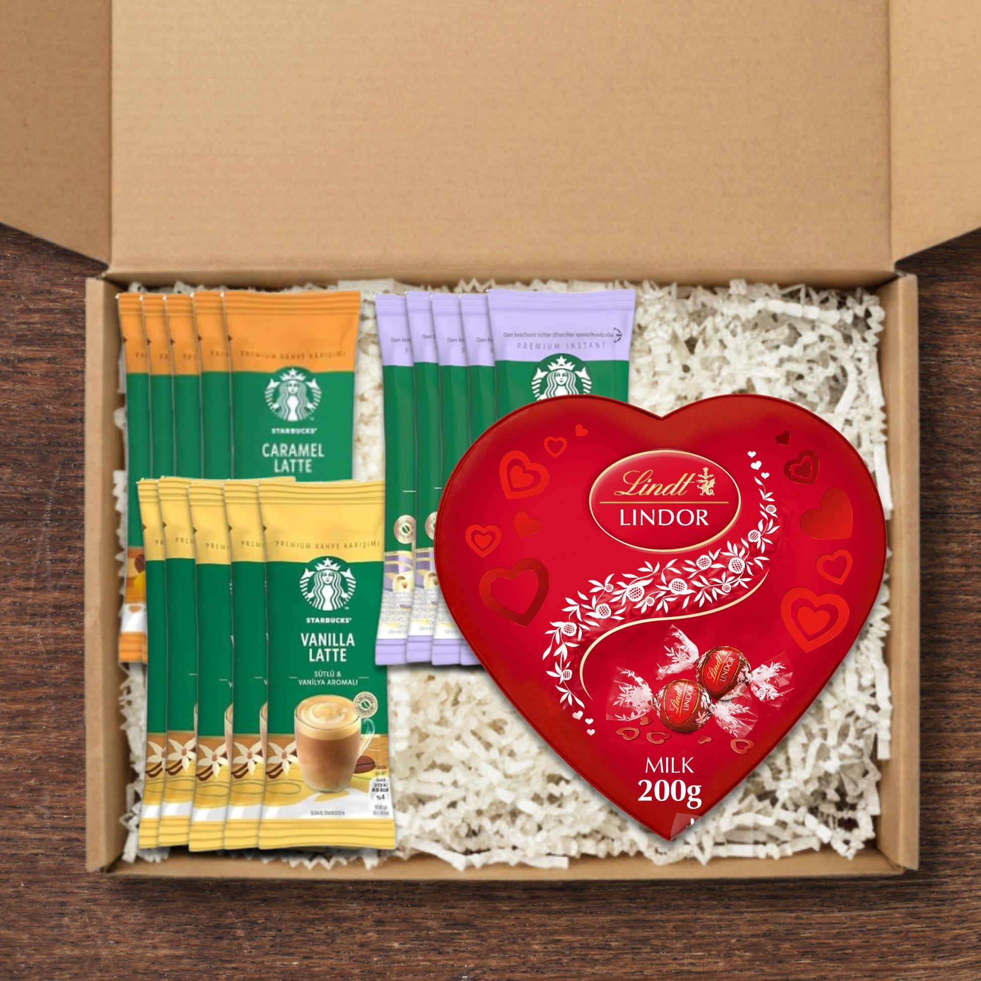 Gift Box containing starbucks coffee sachets and a heart shaped Lindt Lindor box of chocolate truffles