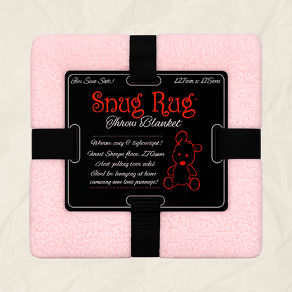 A pink textured throw blanket wrapped with a black strap and a black product label that reads 'Snug Rug Throw Blanket' with size and care text, shown on a light neutral background.