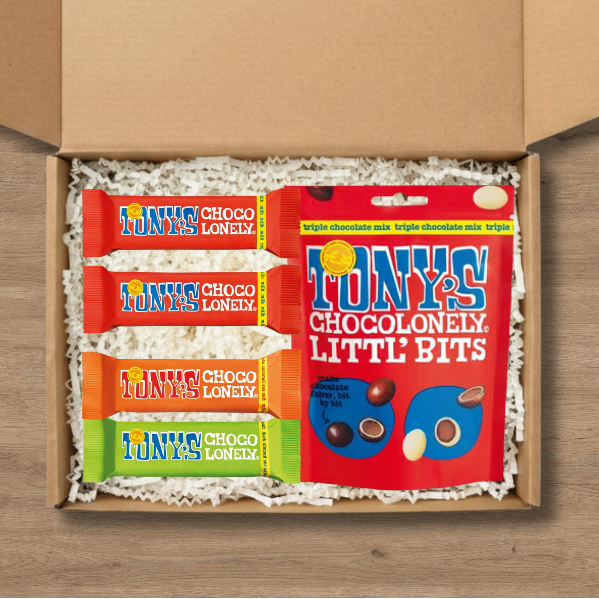 A gift box containing Tony's Chocolonely Littl' Bits, 2 Tony's Milk Chocolate bars, 1 Tony's Milk Chocolate Caramel Sea Salt chocolate bar and 1 Tony's Dark Almond Sea Salt chocolate bar